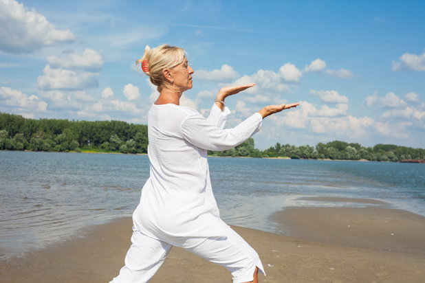 Older woman practices Tai Chi to achieve inner peace