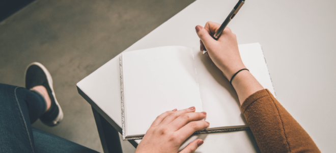 Woman with a pen and empty journal