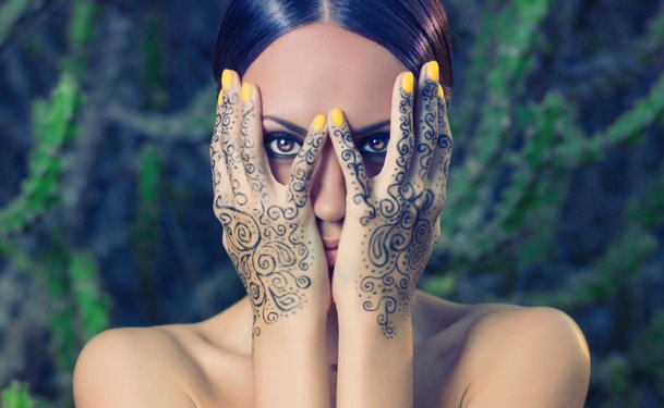 Beautiful Indian woman with henna tattoo on color background Stock Photo |  Adobe Stock