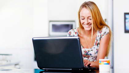 A woman working on a lap top.