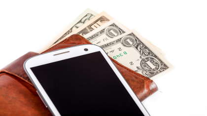 A wallet with smartphone and cash. 