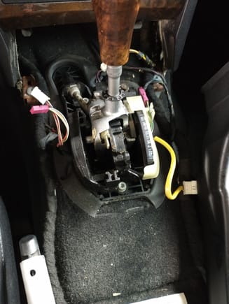 Remove center console to gain access to the 3 bolts holding the auto shifter in place.