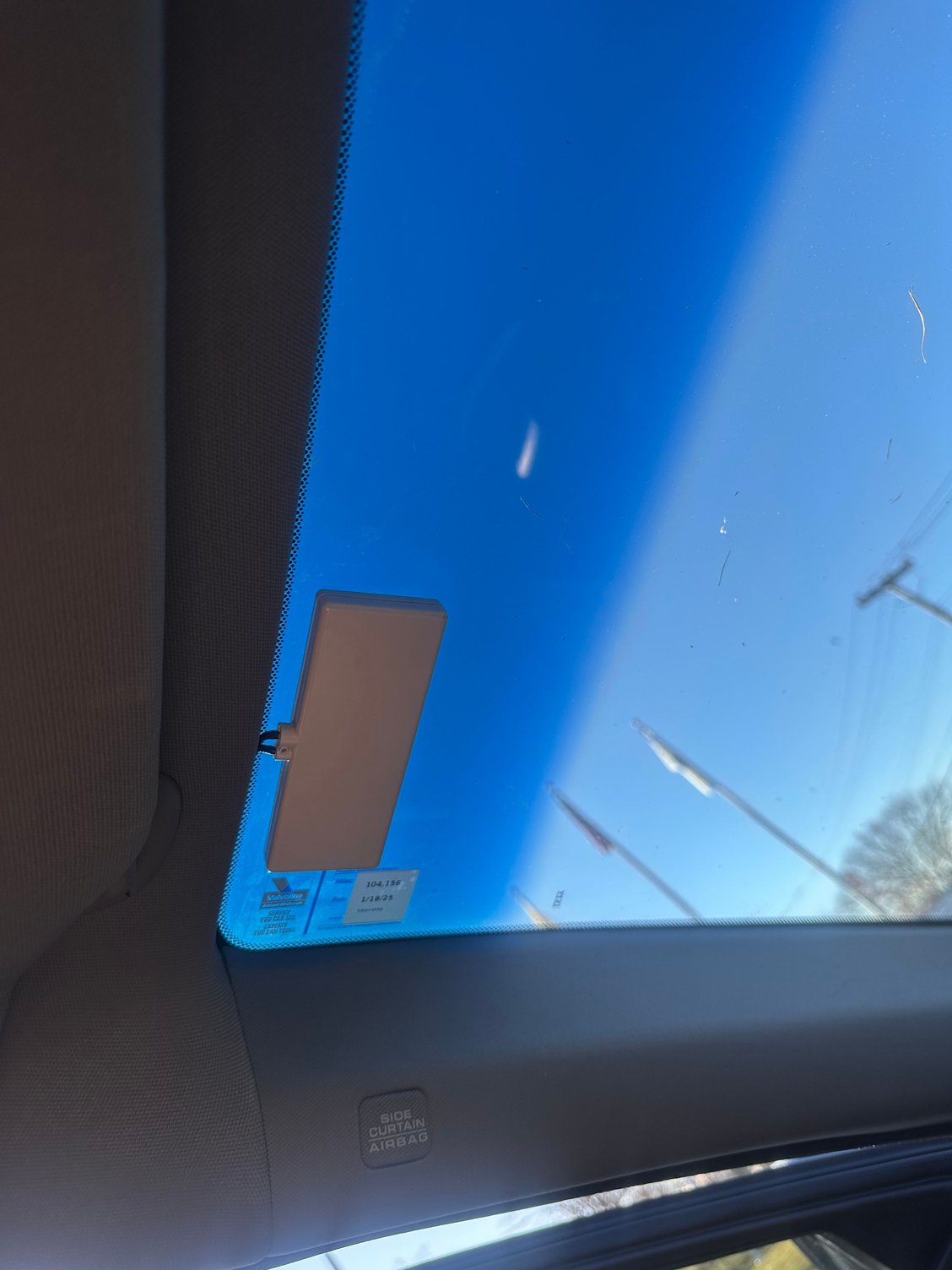 from inside the car. Above drivers seat on top of the windshield. 
