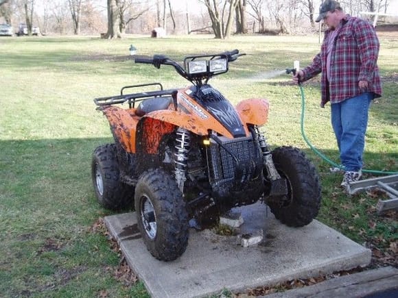 washing my Chrismas present. A new 2006 polaris scrambler with a rear rack, hitch, and a set of ramps. i was a very good boy all year long for this.