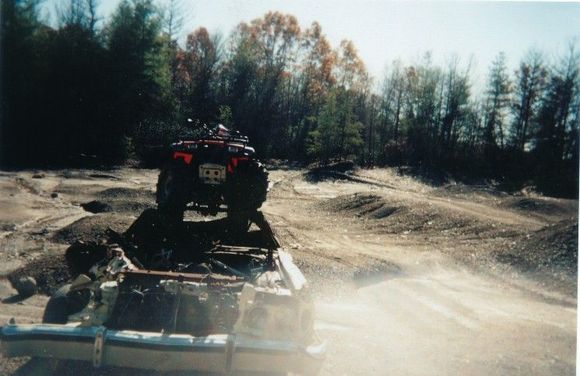 dad climbing on top of the old burnt and crushed car                                                                                                                                                    