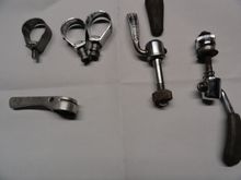 Three lever clamps for late model Campy levers. One shift lever orphan, and two seat clamp quick release mechanism.  One has had the rubber cover pulled off but is a useable unit.