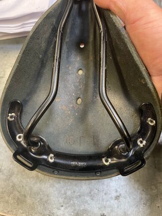 Brooks says made in England inside the frame

And honestly, the rivet work looks cleaner on the knock off. 

For $15, wish I bought it now. (The brown one)