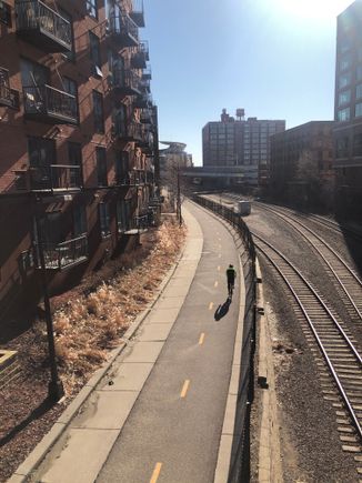 Cedar Lake bike trail and Burlington Northern railroad tracks in Minneapolis’ North Loop neighborhood. The Minnesota Twins baseball stadium can be seen in the background.