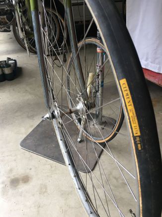 Probably the original front tire. These bikes came with 27" tubulars. The wheel in the background is a 27 x 1 1/4 which he probably had built so he could use clinchers. It's sporting a Schwinn Le Tour.