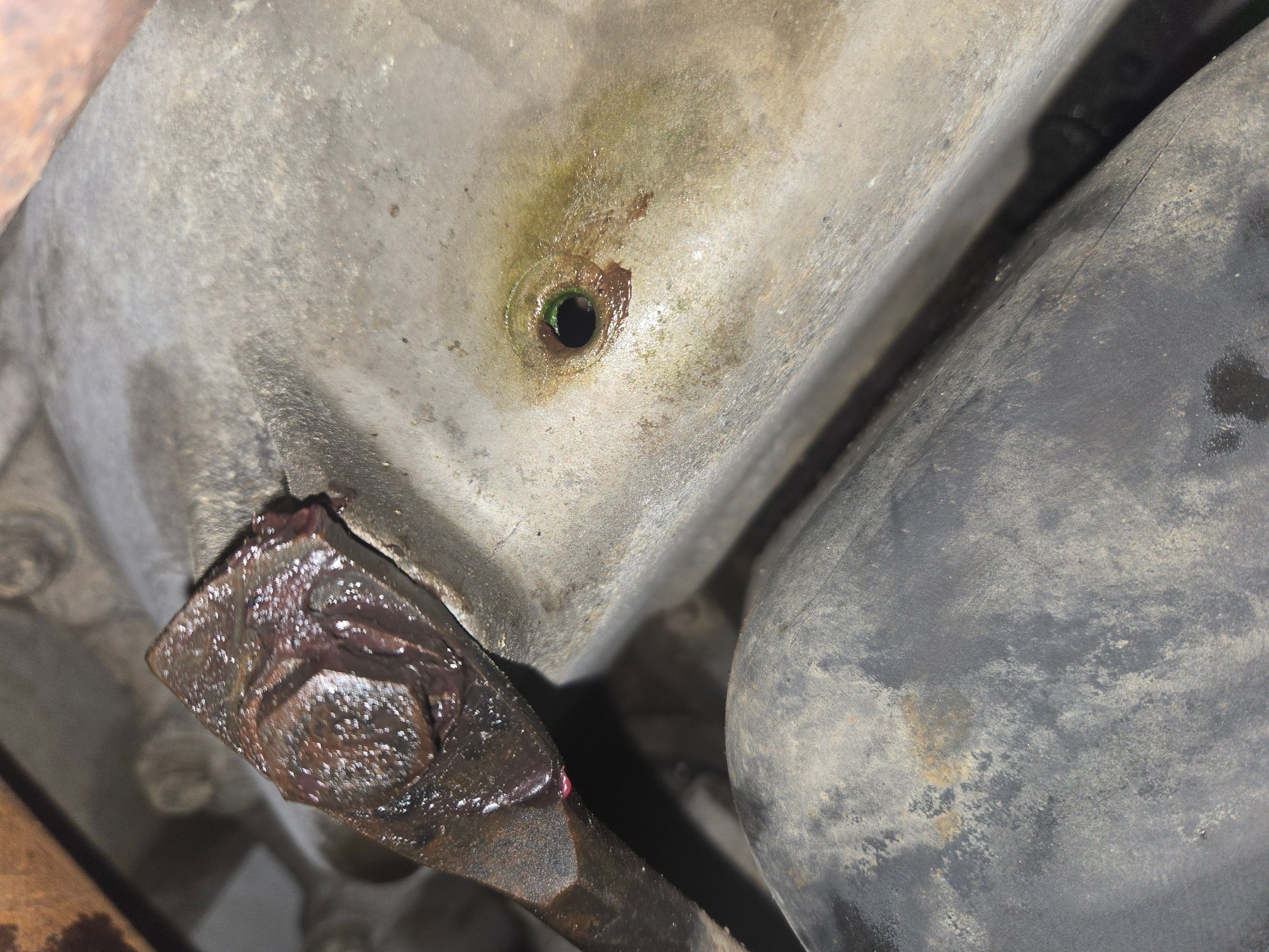 So im learning but what is that part amd is thatdrain hole okay? Its located right behind my oil pan amd right in fromt of my trans fluid pan. 
