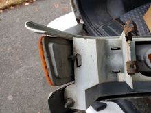 The outboard clip with the black zip-tie that had to be removed to remove the clip. I suspect this zip tie helps prevent this from coming loose on its own. I installed a new zip tie when I reinstalled it.