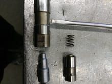 modification of an old hydraulic lifter.
left side is the assembly with a fixed piece of rod turned on the lathe, quick and dirty to have a second lifter to measure.
this effectively makes it a solid lifter without the spring.