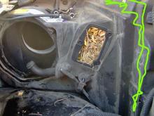 The Computer Climate Control blower motor control module is removed exposing the larch needles and ash tree leaves.