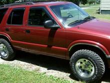 a side picture of my blazer with my new rims and tires.