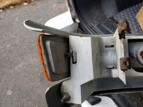 The outboard clip with the black zip-tie that had to be removed to remove the clip. I suspect this zip tie helps prevent this from coming loose on its own. I installed a new zip tie when I reinstalled it.