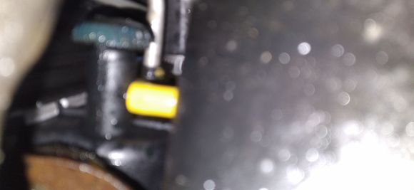 Piece of screwdriver handle i added to the petcock to make it easier to open and close.yelliw cap is to stop a dribble im getting on the new rad. Seems to work.