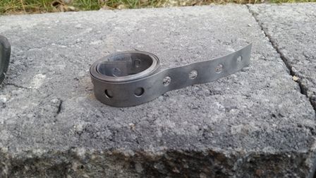 This is exhaust hanger or car stereo hanger. It is easy to cut with tin snips and easy to bend by hand. I wanted to increase the strength of the mount by putting some metal in the mix.
