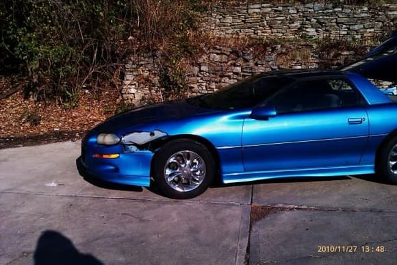 Feel like I'm droping my pants showing ya this...Blue's hurt, but not out the game!!!  Notice the wheels?  Swear they were GREEN AND BLACK before I used the 5 coats of Turtle wax chrome cleaner.  The Quasar Blue is popin in the sun even before the first car wash in three years!!!