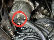 Fuel leak at line connection circled.