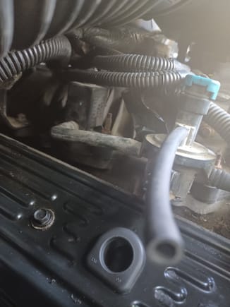 Same issue, pcv valve goes in the hole at the bottom then a hose goes up to air intake.  Not sure if a T goes above the pcv  so you can connect the little vacuum hose to it but thats what it looks like and i saw a T like that on rock auto.  Any information you can share with me would be appreciatted if you figure anything out.  I will post agian if i fix it.