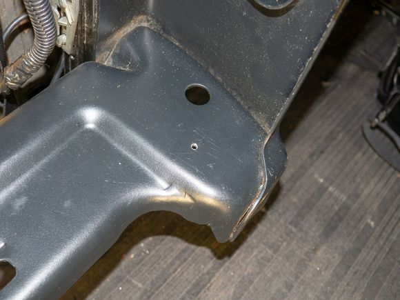A small hole was drilled into the back of the seat base, where a #6 screw could go through and thread into the angle bracket.