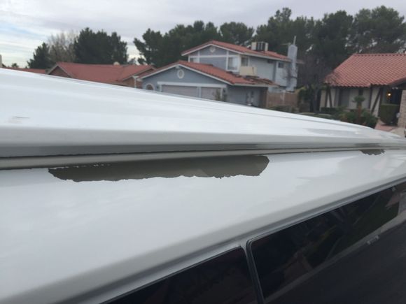 Below the rain gutter.  Happening on both sides.  Idiot Chevy reps saying this problem is due to stone chips?