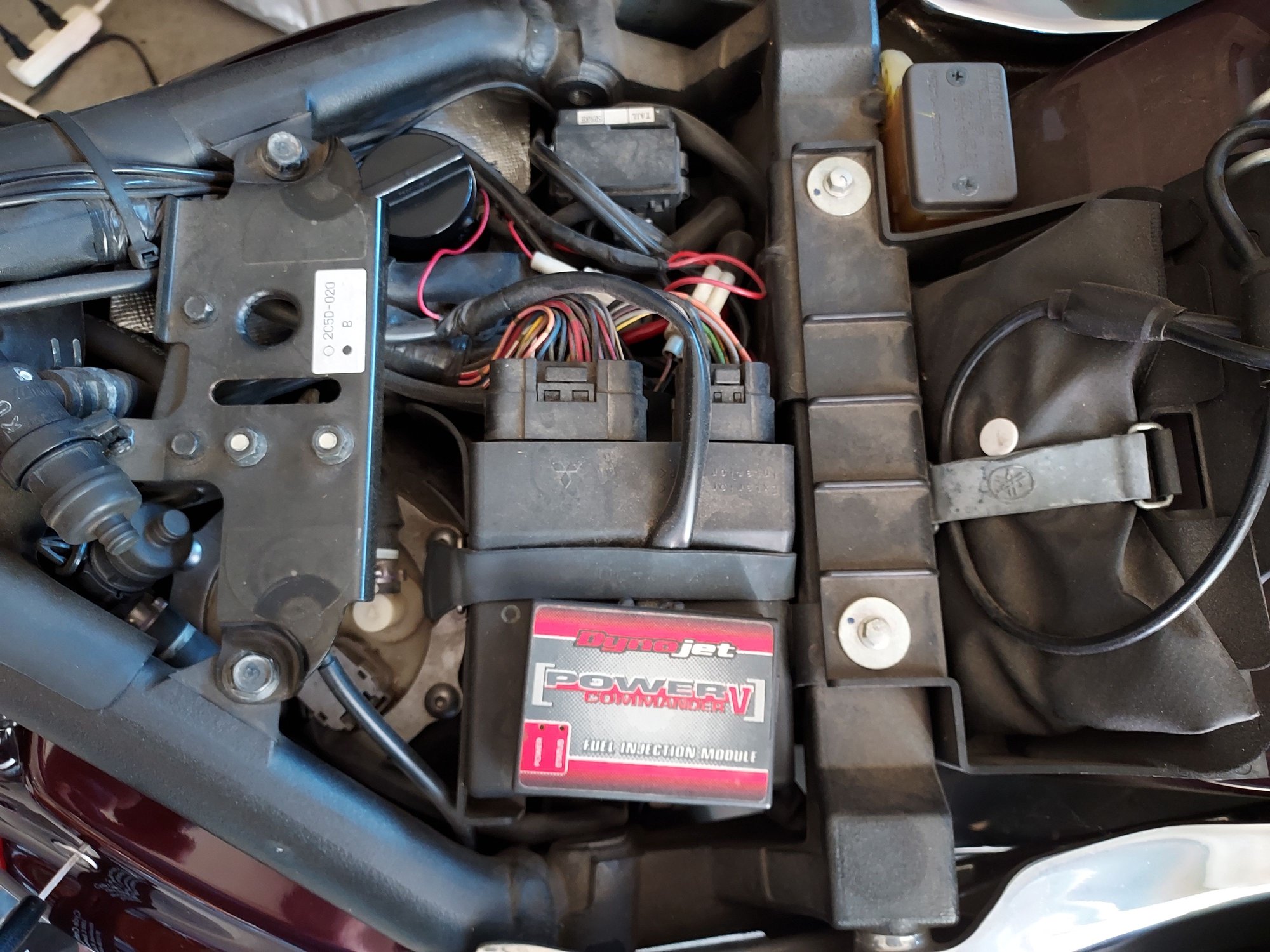 Seat removed and 1st layer exposed.  Power Commander 5 fuel controller/tuner attached to the ECU with Velcro, held down by rubber strap.