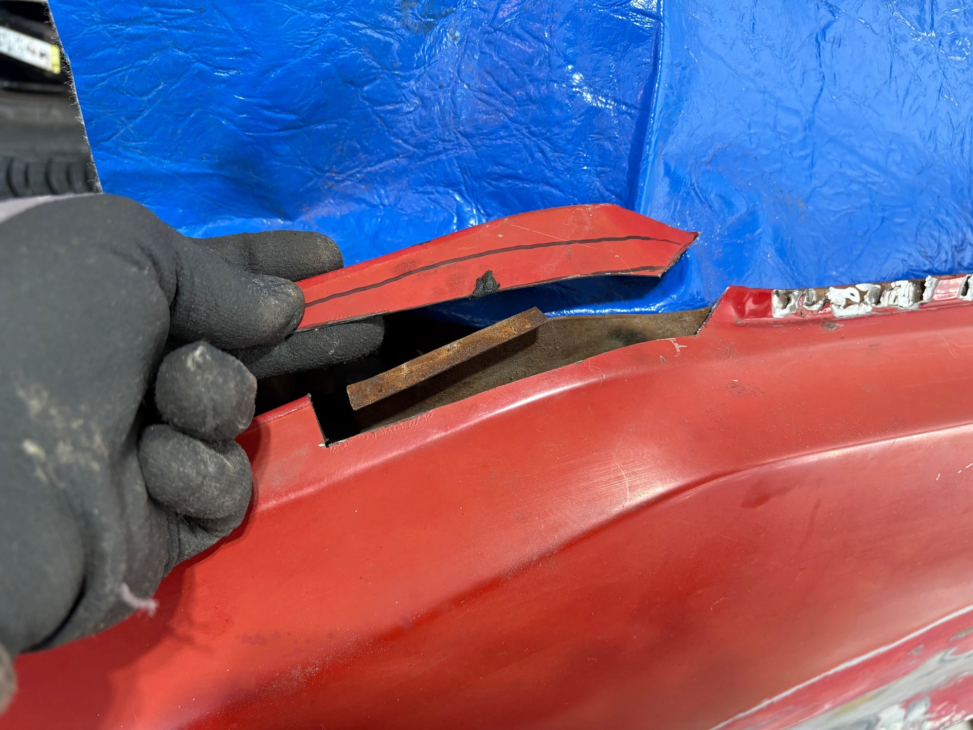 I knew I wanted to fold the panel down and out.  To,do,this just a small piece needed to be cut right where the top bump is.  It hooked and welded to the substructure.  Once removed this enabled the panel to move out and down