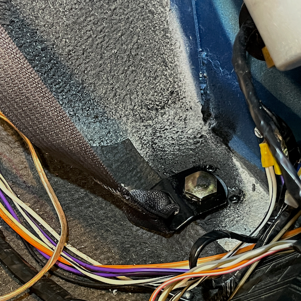 I secured the other end of the retractor belt to the inner rocker floor, below the hydraulic top rams.