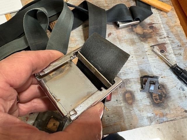 With the spring out, the belt will twist out