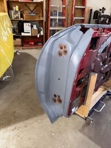 This area of the door would be quite difficult to paint with hinges in place and the door hanging.  I don’t know factory painting sequence.  If anyone does, please chime in.