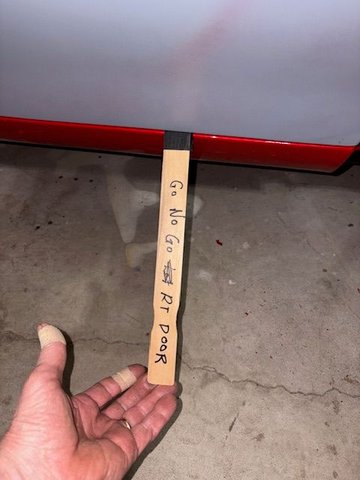 Using a paint stick Go/No Go gauge to check gap between door bottom and sill.  It was exactly as before removal.