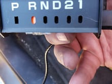 Indicator assembly out of vehicle manually showing how the line is supposed to work