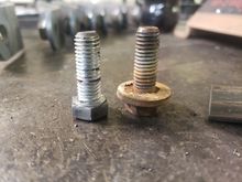 The factory carrier bearing bolts (R) have a free-spinning washer.  I could have used these for my plan but I'd have to weld the washer so it wouldn't spin or cut it off. NO NEED: the bolts which hold the NP241 case halves together (L) are the same thread pitch (M10x1.5 IIRC) and length, and I'm flush with these since I now have two extra t-cases in my white trash wheelbarrow....