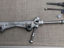 Push the input shaft out the bottom of the receiver. You may need to wiggle the shaft and/or the rack at the same time. Now the rack should slide out of the receiver. 