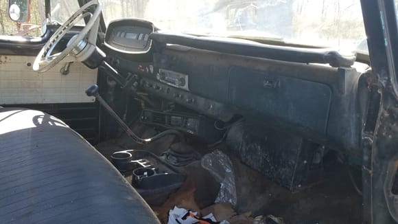 Has an almost unmolested dash, with the factory radio and A/C evap