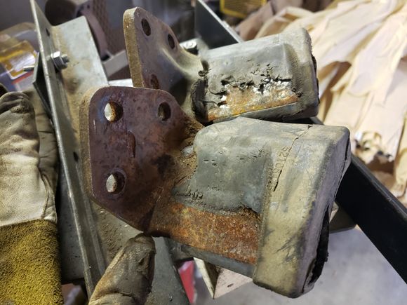 Now THESE are some heavily worn upper overload brackets. Note where on one the spring was actually grooving THE METAL (gloved finger indicates).  