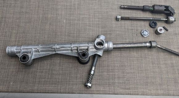 Push the input shaft out the bottom of the receiver. You may need to wiggle the shaft and/or the rack at the same time. Now the rack should slide out of the receiver. 