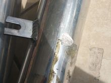 Chip due to strut bar. Also name plate came off due to contact with the strut bar.