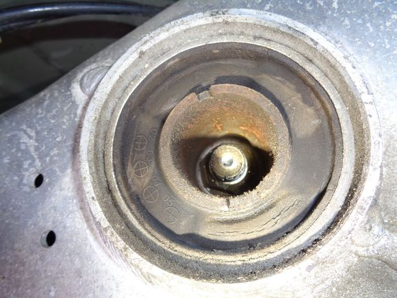 Top and bottom of bushing is indented and wrinkled indicating wear. Sides are solid. I think this bushing is only 1/2 filled with siicone.