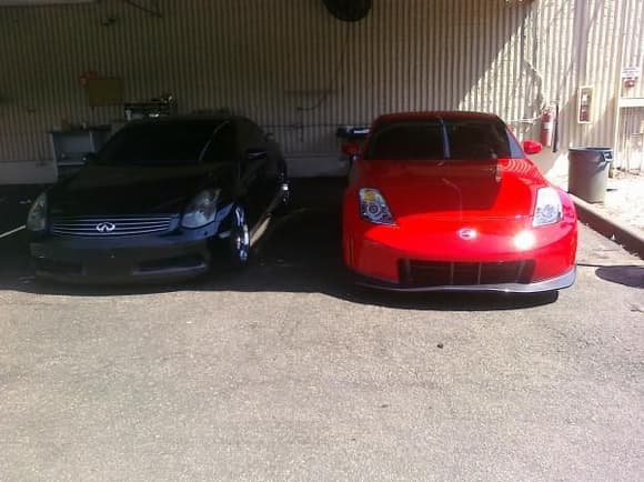 Older picture with original headlights dropped on eibach springs next to a nismo 350z.