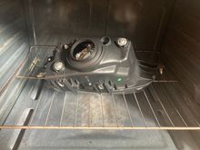 I heated the oven to 240F and then placed the housing in for 10 minutes. That got the adhesive softened up, but I put the housing back in for another 10 minutes and then I was able to separate the glass from the plastic.