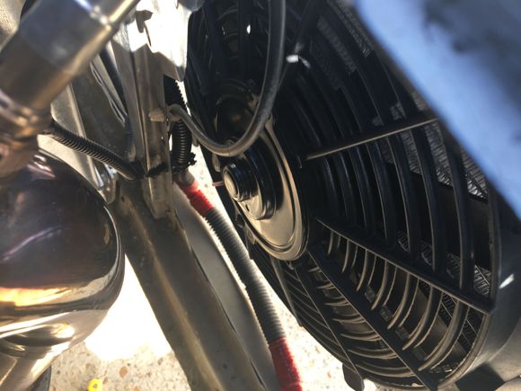 The condenser and fan are married (such a cute couple!) and will live comfortably tucked away from the hot exhaust pipe. As long as the fan isn’t influenced by the hotness of the exhaust, this marriage will last.