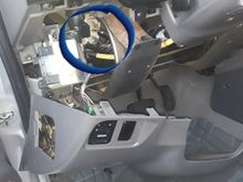 Flasher is behind trim panel shown. To the left of column. Trim has one phillips screw on lower right and two where hood release is. And it pops off to give you access.