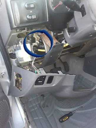 Flasher is behind trim panel shown. To the left of column. Trim has one phillips screw on lower right and two where hood release is. And it pops off to give you access.