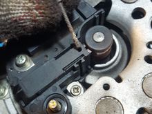 First, I put a small finishing nail (anything small will work, even a toothpick) in this slot to hold the brushes back away from the main shaft.
