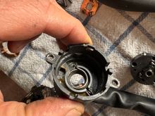 This is the spring that you press against when cranking.
