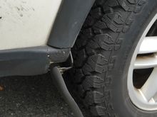 Rear passenger mud flap cracked