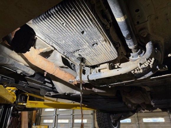 Letting the ATF drain. Color looked good, and the ATF was clean after 50k miles