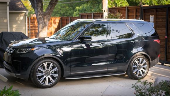 2017 Discovery HSE LUX, Supercharge, Farallon black, vintage tan interior, InControl Pro, 21" 9-spoke diamond turned wheels, Huber Optik tint (30% 1st row, 70% 2nd row and rear, 5% windshield), various added brushed silver trim plates (side mirrors, window controls, etc.), fixed side step, mud flaps, wheel locks, silver painted roof rails, gloss charcoal oak veneer.